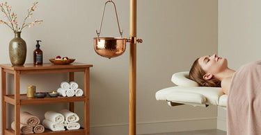 Luxurious Shirodhara Ayurvedic treatment set with wooden vessel and spa accessories for professional relaxation services