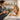 Spa professional giving a glass of water to a relaxed client after a massage, illustrating post-massage hydration myths and aftercare advice.