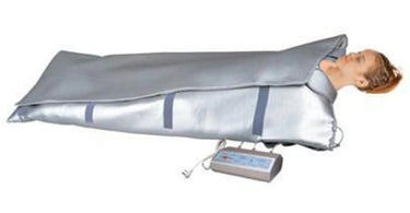 Premium 3 Zone Heating Blanket 30x68 draped over a professional massage table in a spa setting for client comfort.