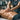 A massage therapist's hands applying cream to a client's back during a deep tissue or sports massage treatment