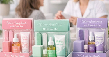Retail bundles for nails between appointments kits displayed on a manicure table with cuticle oil, hand cream, nail file, and other professional nail care products