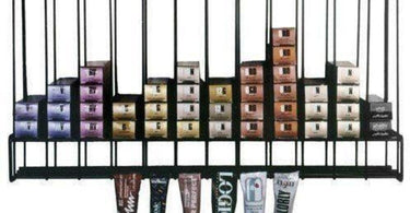 Metal salon hair color tube storage rack mounted on wall, designed to optimize salon color organization