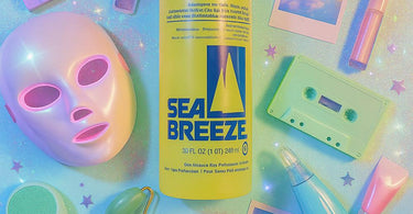Sea Breeze Astringent bottle with refreshing blue liquid beside spa towels and skincare tools