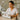 Esthetician organizing wholesale skincare supplies in modern spa