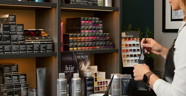 A selection of professional hair color products displayed in a salon setting