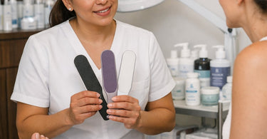A professional pedicurist selecting the correct foot file grit for different callus types, showcasing stainless steel foot files and abrasive grit options for salon use.