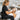 Therapist sitting correctly on an adjustable stool in a spa treatment room demonstrating proper posture to prevent lower back pain