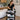 A mobile esthetician's organized cart with professional skincare and waxing supplies