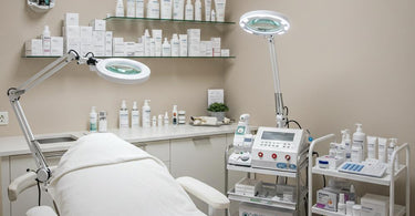 A serene and well-organized facial room setup with essential spa equipment