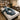 A serene and safely equipped prenatal massage room setup featuring a specialized massage table with bolsters, pregnancy-safe oils, and soft lighting