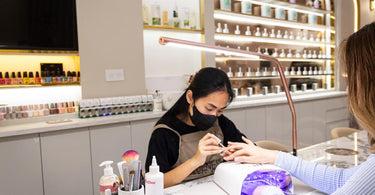 Slimline 4 Table Lamp in Rose Gold illuminating a manicure station