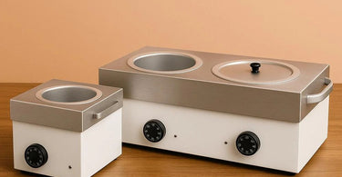 Professional large wax warmer next to small wax pot, showing size comparison for salon use