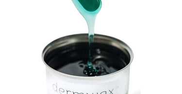 Esthetician applying soft wax on a client's leg in a professional spa setting