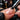Close-up of a nail technician applying acid-free primer to a client's natural nail, demonstrating precise brushwork for a flawless base.