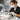 Nail technician using a dust collector and safety mask during gel removal service