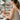 A nail technician performing an ergonomic manicure on a client, with proper wrist support and both maintaining good, relaxed posture.