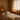 A serene and inviting spa treatment room, showcasing a neatly made massage table with fresh linen, warm lighting, and essential tools like a towel steamer and wax warmer ready for a client, embodying the perfect first impression.