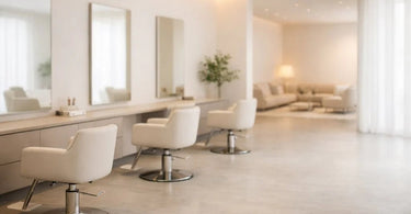 A bright and airy modern salon interior showcasing minimalist design with clean lines, a single massage table, and an uncluttered space emphasizing the concept of negative space for a calming client experience.