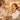 A spa client looking into a mirror with a surprised and delighted expression, having a moment of realizing their own beauty after a professional treatment.