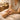 A spa professional performing a detailed hand and arm massage on a client, using warm oil, in a serene treatment room.