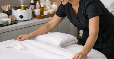 Professional aesthetician gently recommending a facial add-on service to a relaxed client in a spa treatment room, illustrating the art of the upsell.