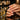 Close-up of a professional applying cuticle oil with a brush to dry, damaged nails during a salon manicure treatment