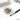 A professional brow artist applying creamy tint to a client's eyebrow for crisp edges without bleeding