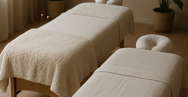 Professional spa setting showing both heavy and light draping blankets on massage table
