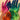 Close-up of a hair colorist's hands, showing subtle stains and holding a hair color brush, with bowls of hair dye in the background.