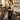 A hair colorist with perfect posture, smiling confidently while working on a client in a modern, ergonomic salon setup.