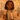 Professional colorist analyzing client skin tone and hair color results in a modern spa setting