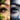 Comparison of organic and synthetic lash tint formulations displayed on a professional salon workspace with applicators.
