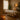 A serene spa treatment room featuring a beautiful woven basket filled with smartphones, symbolizing the beginning of a relaxing Digital Detox Facial experience.