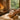 A serene spa treatment room setup for the Executive Decompress protocol, featuring a massage table, warm towels, hot stones, and aromatherapy diffuser.