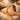 A peaceful, close-up image of a client receiving a gentle, nurturing facial treatment with warm towels and caring hands, evoking a sense of safety and quiet comfort.