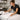 Graphic illustration of a stressed new salon owner surrounded by floating money, broken equipment, and receipts, highlighting common first-year financial pitfalls.