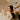 Stylist coaching a client on at-home hair care, showing professional shampoo and conditioner bottles with a warm, friendly interaction