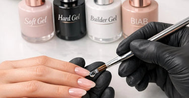 A professional nail technician's hands applying builder gel to a client's natural nail, with bottles of soft gel, hard gel, and BIAB in the background.