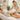 A variety of professional massage bolsters in different shapes and sizes arranged neatly on a spa treatment table, showcasing tools for client comfort and support.