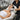 Esthetician comfortably working on client using an adjustable height facial chair from Pure Spa Direct to prevent back strain