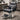 A close-up view of a professional salon chair, highlighting the plush, adjustable armrest designed for client comfort and ergonomic support during long beauty services.