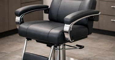 A close-up view of a professional salon chair, highlighting the plush, adjustable armrest designed for client comfort and ergonomic support during long beauty services.