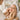 A serene spa treatment scene where a client's eyes are closed, smiling as their fingertips gently touch their own cheek, feeling the smooth results of a facial treatment, with an esthetician smiling in the background.