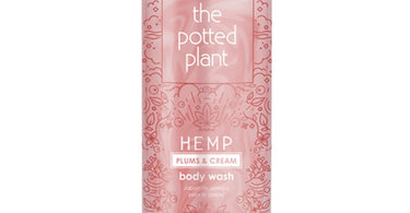 The Potted Plant Plums and Cream Body Wash in a large 33.8 fl oz bottle, featuring a label with plums and the brand name, set against a light background.