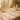 A spa professional warmly greeting a client with a digital tablet intake form in a serene treatment room