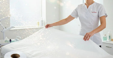 Professional poly-backed table paper with perforations for easy tear-off, ideal for spa and salon treatments