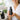 A collection of sleek matte black bottles and jars for spa and salon products, arranged elegantly on a marble surface