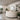 Modern salon interior design featuring a curved white accent wall and sleek, straight-lined salon chairs, illustrating the psychology of curves vs. lines.