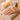 Close-up of a woman's hands with natural, naked nails being cared for by a professional nail technician