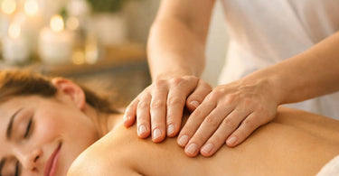 Close up of professional hands with confident, grounding hand placement on a client's back during a spa treatment, emphasizing the psychology of touch and proper technique.